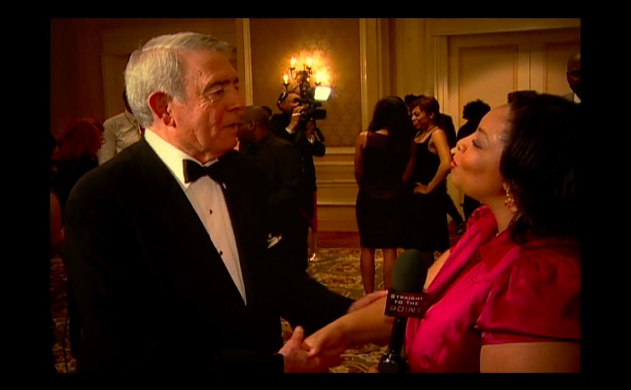 Tamika Felder, then a young TV producer, interviewing Dan Rather at an event