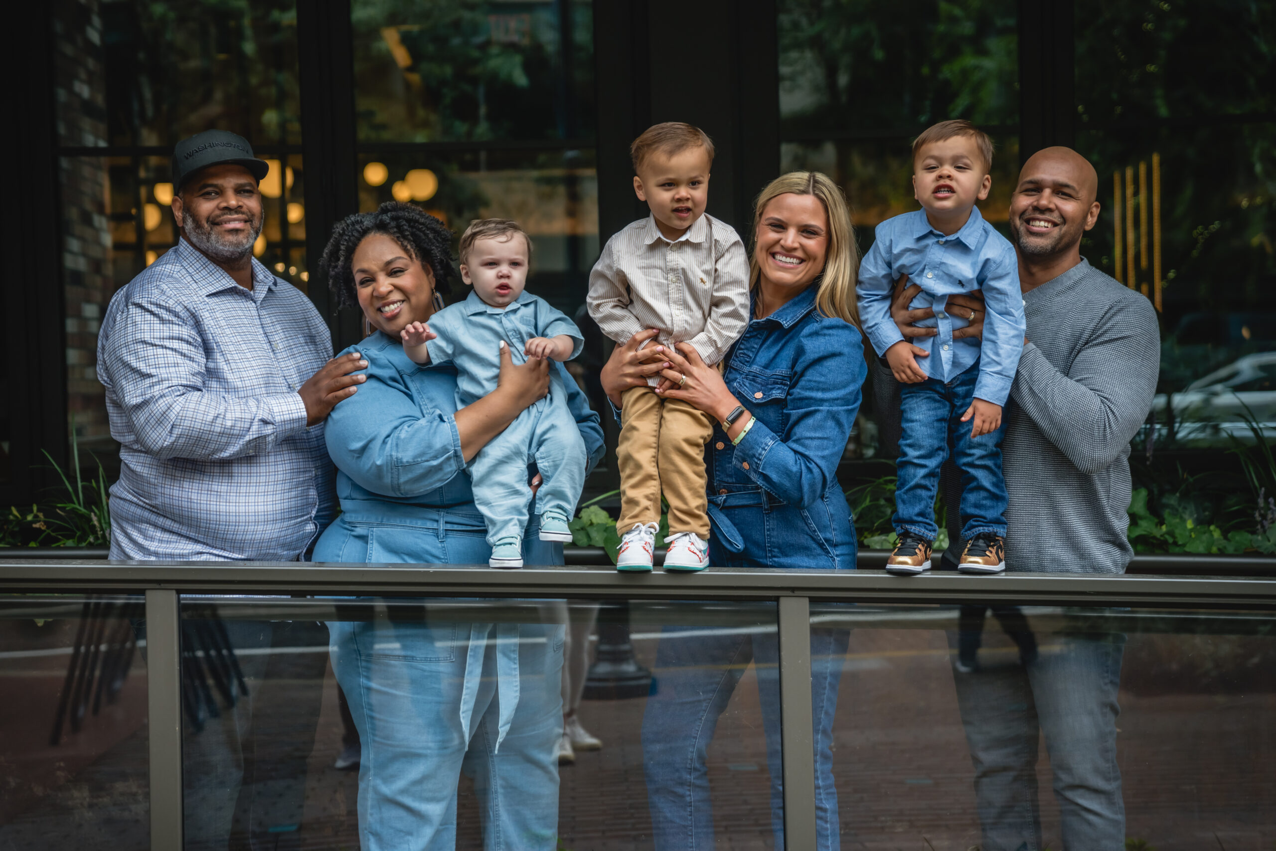 Tamika Felder, her husband Rocky, and their son Chayton, who was born through embryo donation and surrogacy, pose with Ginny and Sean Marable. Ginny and Sean, who donated their embryo after having twins, Emmett and Grant, share a moment highlighting their shared fertility journeys.