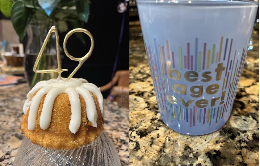 Tamika Felder's birthday treats for herself: A small bundt cake with candles shaped as the number 49, and a Starbucks glass that says "best age ever!" on a table.